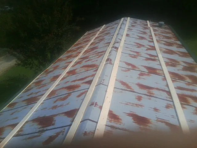 Rusted metal roof panels with new wood purlins before replacement — Storm Damage Roof Repair in Gap by Roofing Brothers