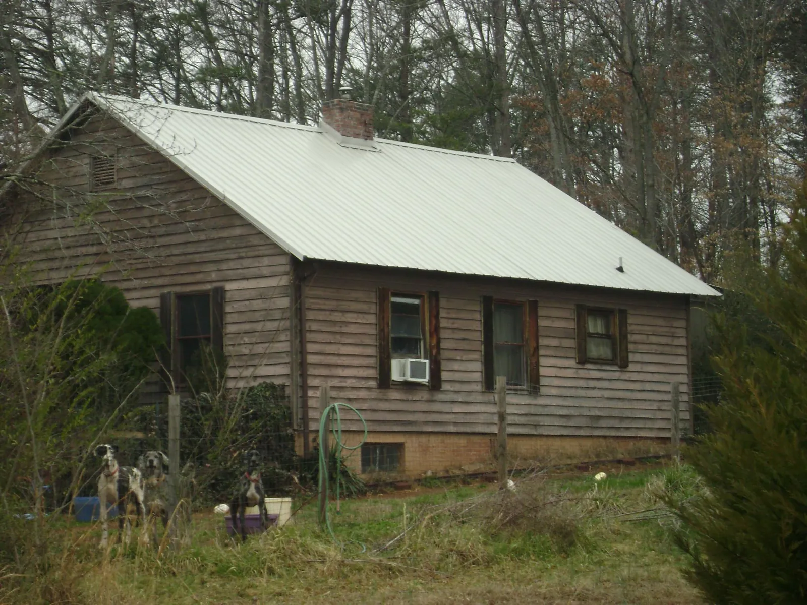 White metal roof on an old wood sided farmhouse, from a Metal Roof Installation job in Gap